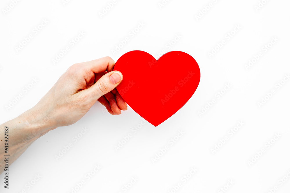 Red heart in female hands. Valentines day or health care concept Red heart in female hands. Valentines day or health care concept