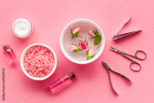 Manicure scissor and hands care cosmetics set with flowers.