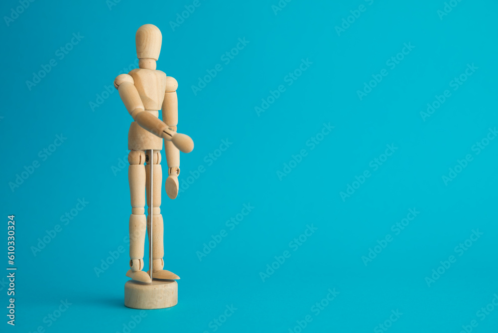 Wooden man figure on blue background copy space. Human resource (HR) in business company, headhunter recruitment, job interview and course training development skill concept. Wooden man figure on blue background copy space. Human resource (HR) in business company, headhunter recruitment, job interview and course training development skill concept.
