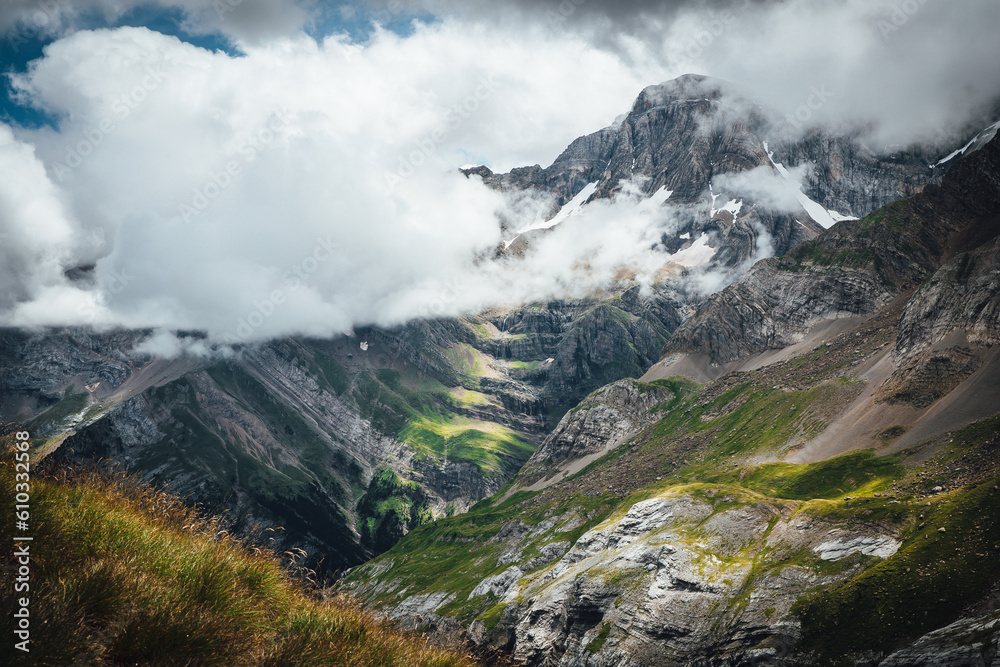 Sunlight into clouds in the mountain with a waterfall