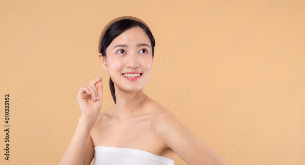 beauty asian young woman model with fresh glowing hydrated facial skin. girl person with natural makeup and healthy skin portrait isolated on beige studio background. spa treatment, skin care concept. beauty asian young woman model with fresh glowing hydrated facial skin. girl person with natural makeup and healthy skin portrait isolated on beige studio background. spa treatment, skin care concept.