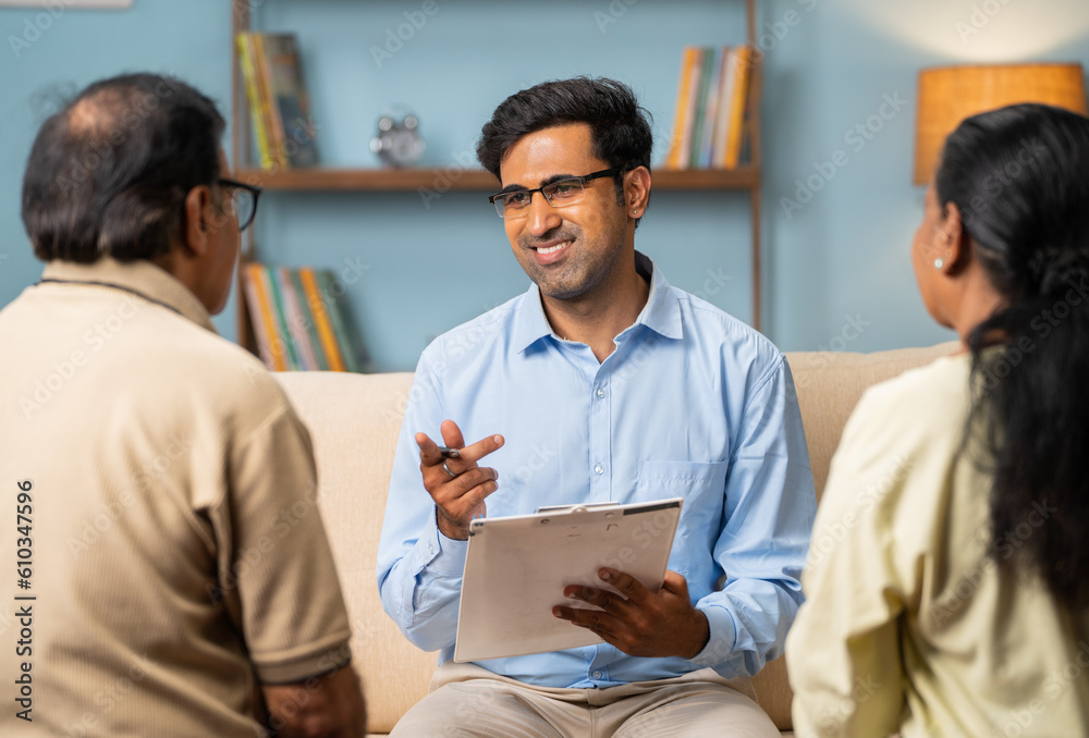 Shoulder shot of indian senior couple explaining problems to psychologist at home - concept of conversation, frustration and counselling Shoulder shot of indian senior couple explaining problems to psychologist at home - concept of conversation, frustration and counselling