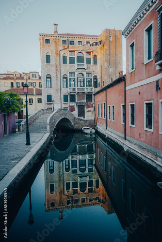 A reflection scene of one of the canals with and old building at the back in Venice, Italy