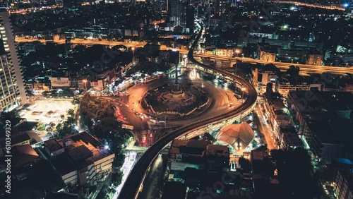 Car traffic on the road at victory monument roundabout and electric train at Bangkok
