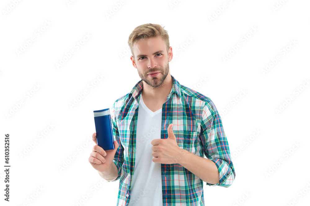 man with haircare cosmetics on background, thumb up. man with haircare cosmetics in studio. man with haircare cosmetics on background, thumb up. man with haircare cosmetics in studio.