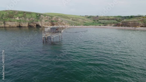 Impressive fishing platforms on stilts on the trabocchi coast of Abruzzo, Punta Aderci, Italy 4k drone