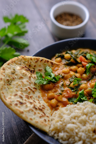 Vegan Chickpea curry on a dark background. Close-up. Healthy vegetarian food concept. Traditional Indian food concept.