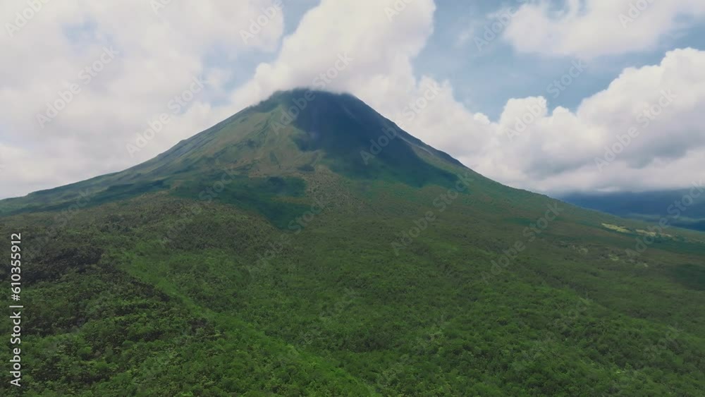 Amazing view of beautiful Arenal volcano in Costa Rica. Panorama of volcano Arenal reflected on wonderful picturesque lake, La Fortuna, Costa Rica. Central America. Amazing view of beautiful Arenal volcano in Costa Rica. Panorama of volcano Arenal reflected on wonderful picturesque lake, La Fortuna, Costa Rica. Central America.