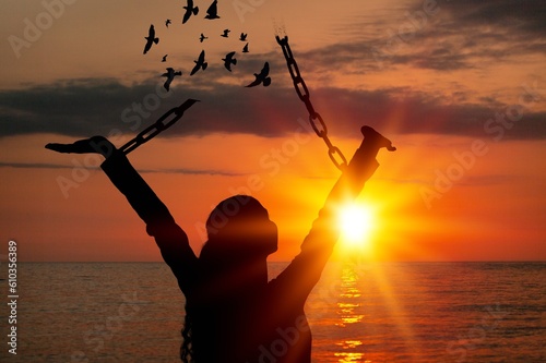 The woman breaking steel chains with free birds photo