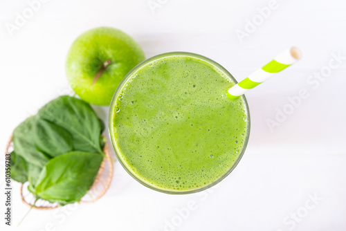 Spinach juice smoothie and green kiwi juice drink healthy, delicious taste in a glass for weight loss on a white wooden background.