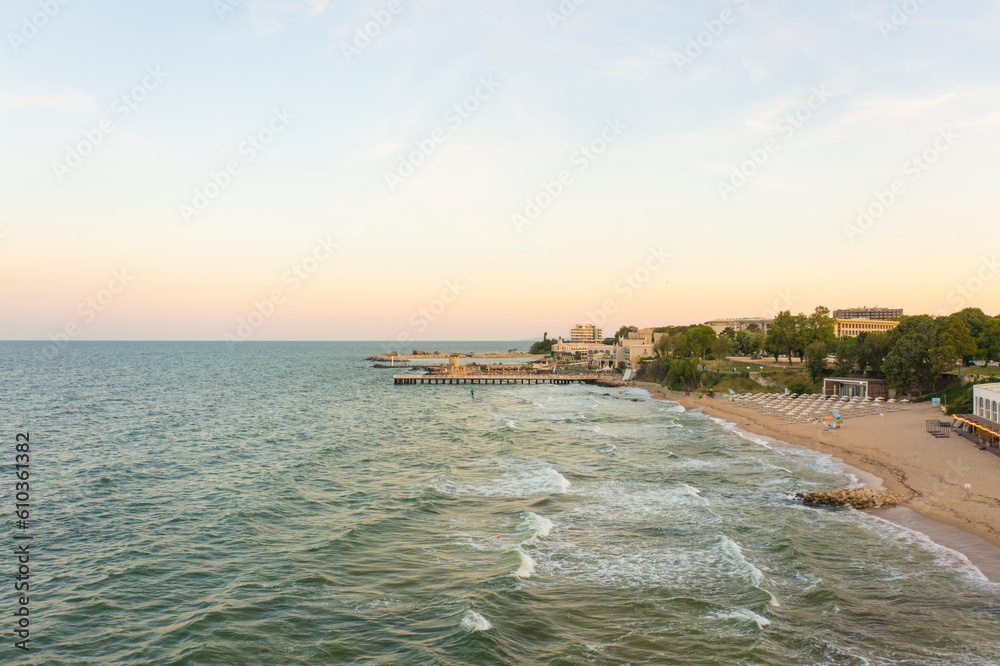 Fototapeta premium Aerial view of Sts. Constantine and Helena Resort beach with hotels at sunset golden hour. Black sea vacation in Varna. Travel to Bulgaria