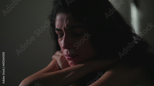 Fotografia Fragile young woman struggling with mental illness in dar room