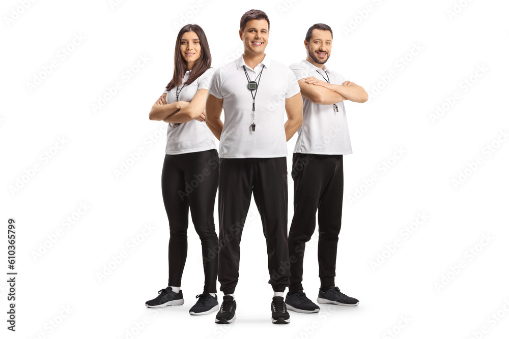 Full length portrait of male and female sport coaches with whistles posing Full length portrait of male and female sport coaches with whistles posing