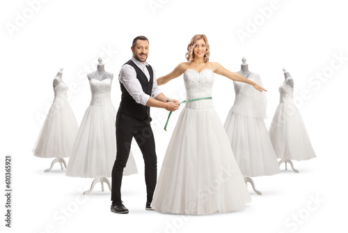 Bridal dress tailor taking measures for a gown