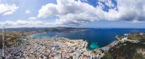 Wide angle large aerial photo of the beautiful town of Sant Antoni de Portmany in Ibiza Spain showing the whole of the town and ocean beach front in the summer time.