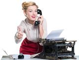 Retro woman working in office with vintage typewriter and phone, dressed in pin-up style