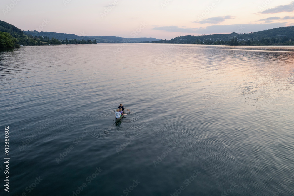 aerial footage of people kayak during sunset in the lake in Switzerland
