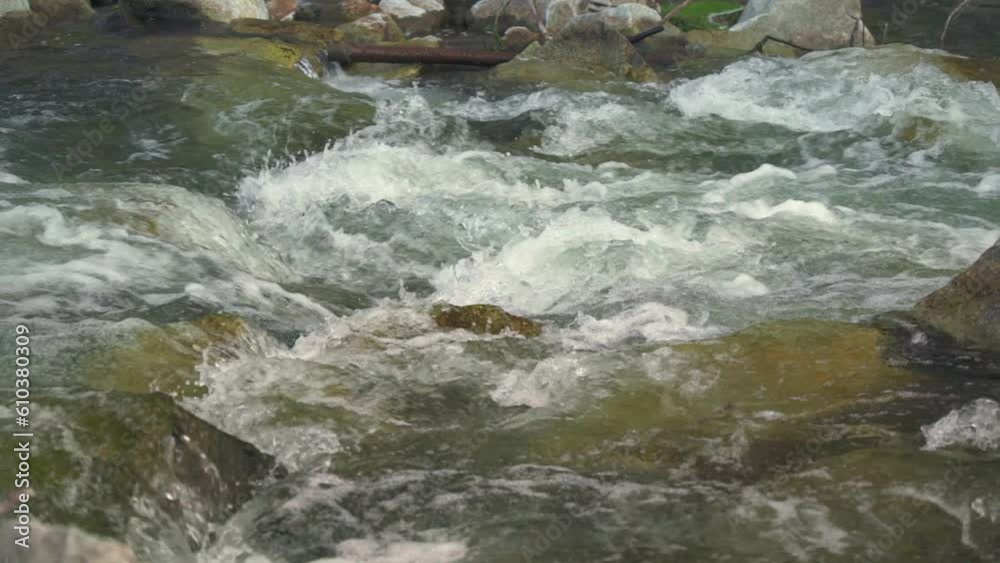 River flowing over rocks cascade on sunny day, closeup detail, slow motion video River flowing over rocks cascade on sunny day, closeup detail, slow motion video