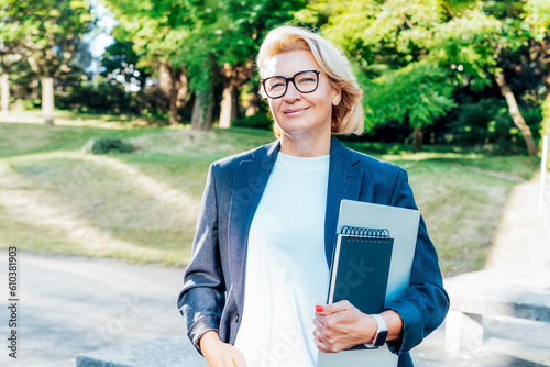 Portrait of 50's confident mature businesswoman looking at camera, middle aged company ceo director, experienced senior female professional, business coach team leader posing outdoor in office park