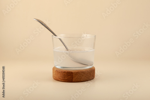 Xanthan gum solution in clear glass. Xanthan gum is found in many foods and is in great demand in cosmetics industry. Food additive E415. Stabiliser and Thickener photo