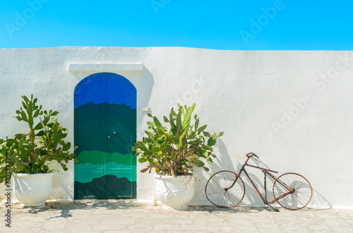 The  Blue door with cactus and the traditional white walls in the town of Ostuni (Puglia - Italy).