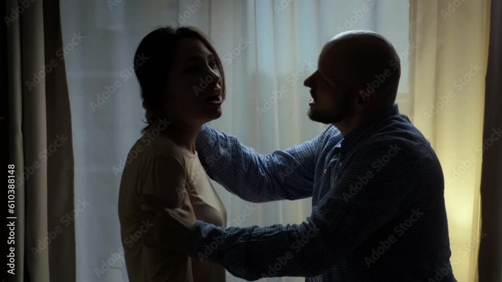 The husband attacks his wife. He pinches her hair. She is afraid and screams in horror. The woman was a victim of domestic violence