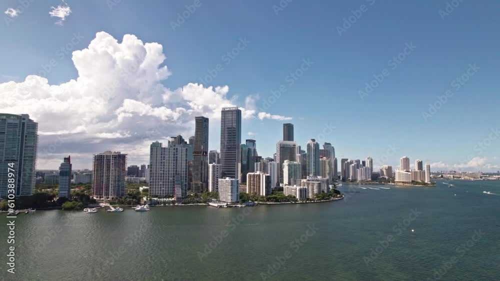Establishing aerial orbit drone shot of Brickell district Miami Florida. Blue cloudy sky. yachts stay in marina. Skyscrapers and modern buildings. Establishing aerial orbit drone shot of Brickell district Miami Florida. Blue cloudy sky. yachts stay in marina. Skyscrapers and modern buildings.