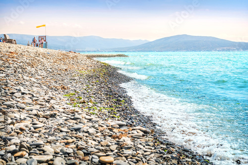 Emerald Black Sea and rocky shore, sun loungers and umbrellas, Aleksino, Krasnodar Territory, Novorossiysk