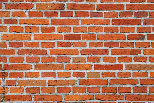 Texture of an old damaged orange brick wall as an architectural background