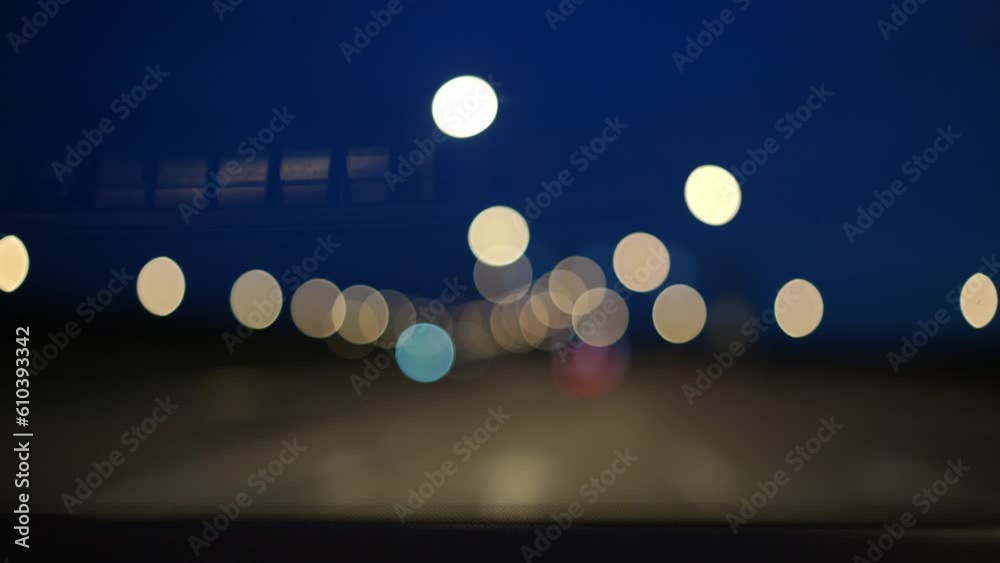 Blurred lights evening city traffic bokeh. Defocused night city traffic. Blurred lights bokeh car headlights driving evening city road. City night traffic background Blurred lights evening city traffic bokeh. Defocused night city traffic. Blurred lights bokeh car headlights driving evening city road. City night traffic background