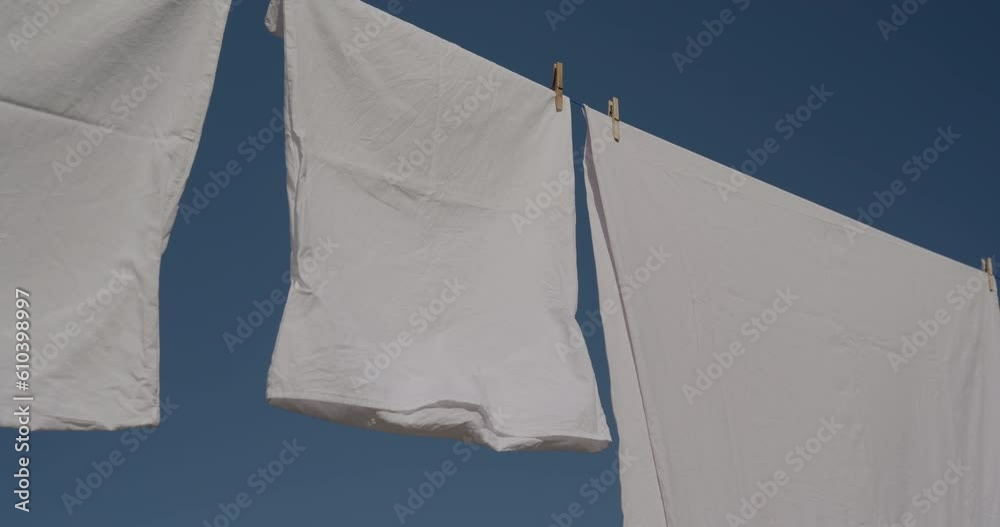 Sheets hanging to dry on a laundry line	

