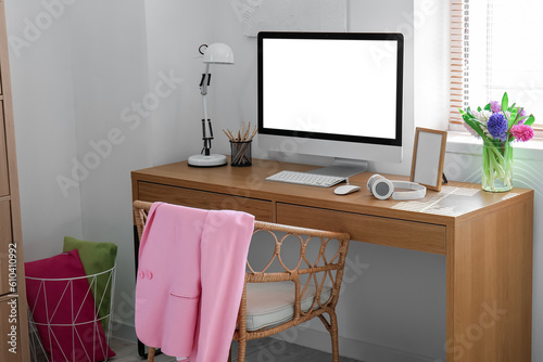 Comfortable workplace with modern PC and beautiful hyacinth flowers © Pixel-Shot