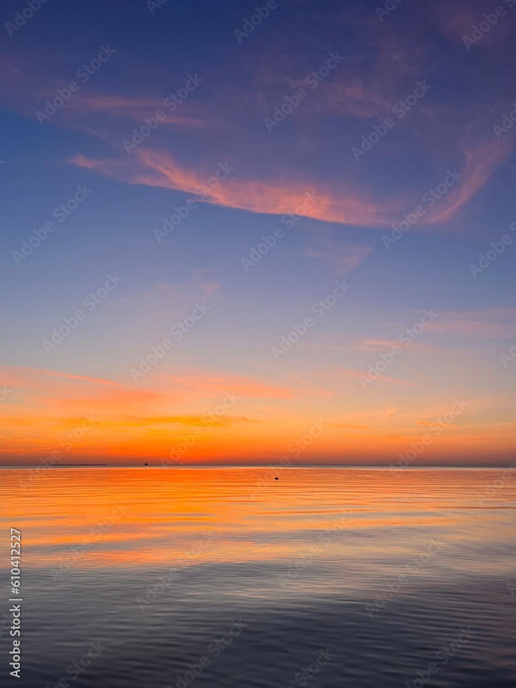 Orange sea horizon, evening seascape background, natural colors, calm water surface reflection