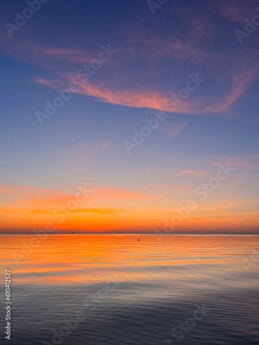 Orange sea horizon  evening seascape background  natural colors  calm water surface reflection