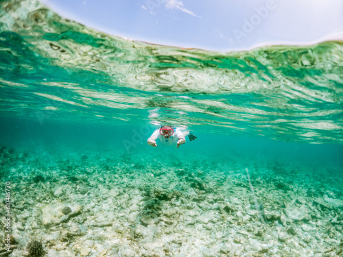 Fototapeta Naklejka Na Ścianę i Meble -  woman snorkeling in clear tropical sea