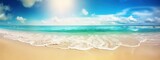 Colorful summer landscape with beautiful golden sandy beach with light rolling waves of turquoise sea against blue sky with clouds