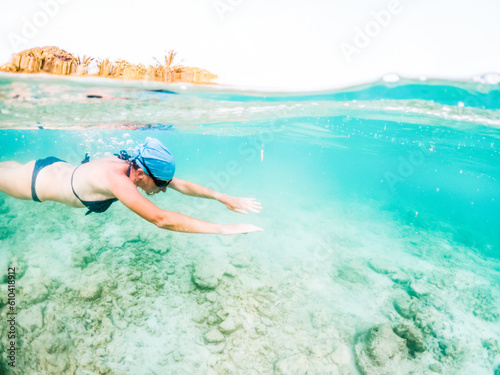 woman snorkeling in clear tropical sea