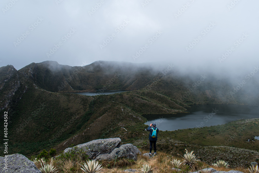 Man taking a selfie in paramo mountain path in a cloudy day 