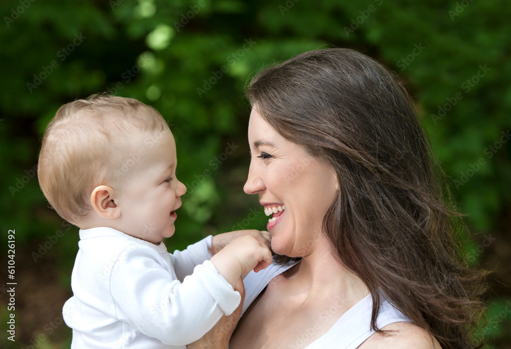 Portrait of mother with young child outdoors. Portrait of mother with young child outdoors.