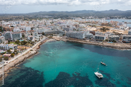 Aerial drone photo of a beach in the town of Sant Antoni de Portmany on the island of Ibiza Balearic Islands Spain showing the ocean front and Cala Alto de Porta beach in the summer time. © Duncan