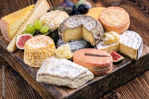 Traditional party platter with soft cheese and fruits served  as close-up on a rustic wooden design board photo