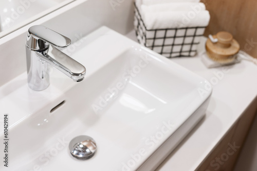 Fotografija design of mixer and washbowl in home washroom