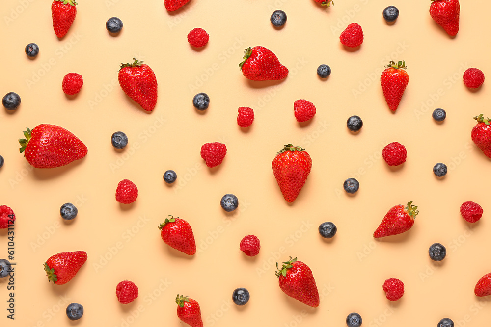 Different fresh berries on orange background