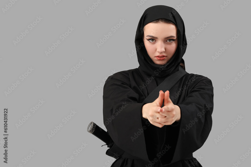 Female ninja on grey background Female ninja on grey background