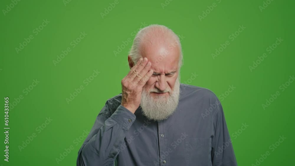 Green Screen.Portrait of an Old Man Having a Headache and Takes Pills. An Elderly Man Feeling Sick and Having Painful Head Feelings. Prevention of Diseases in Adulthood.