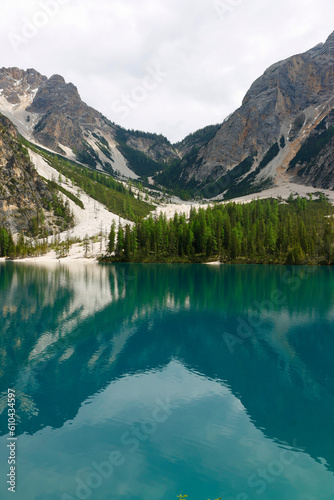 Fototapeta Naklejka Na Ścianę i Meble -  Landscape view of the emerald smooth surface of Lago di Braies in the Dolomites, northern Italy, Europe