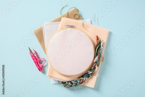 Konstfotografi Flat lay composition with embroidery hoop and sewing accessories on blue background