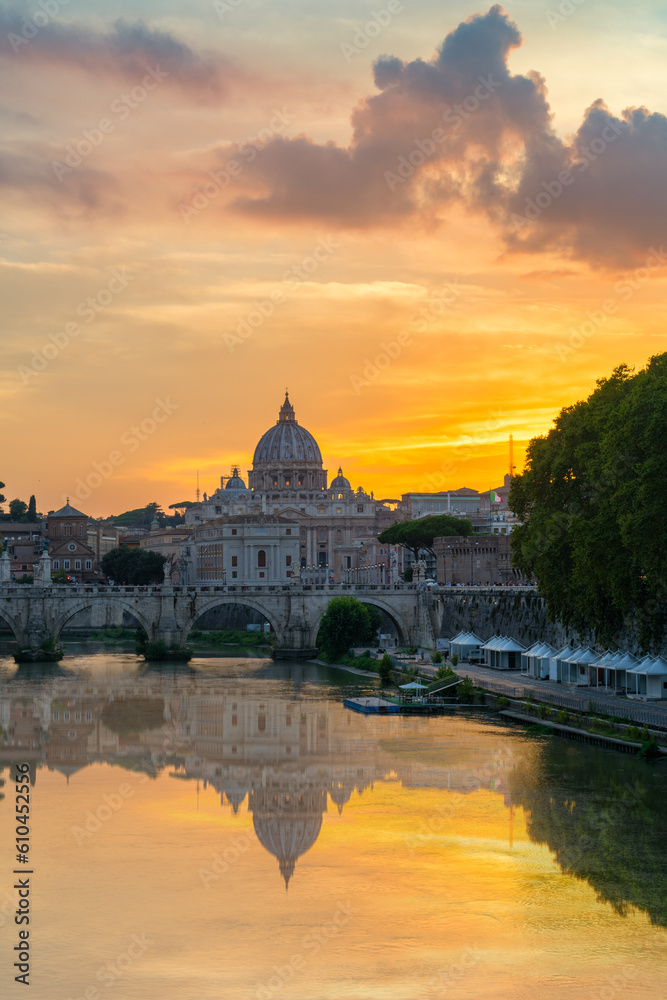 St. Peter's basilica across Tiber River canal at sunset in Rome, Italy