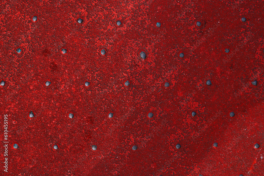 Grunge steel industrial boat floor plate painted dark vivid red anti-rust paint. Robust ferry ship metal pattern. Old dotted iron deck. Worn metal texture background. Modern design concept. Copy space