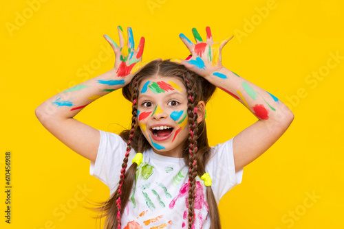 Children's creativity, a child is engaged in drawing, A funny little girl painted with colorful paints, Creativity and drawing for children.